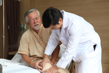 Fototapeta premium Physiotherapist or doctor checking with patient in hospital