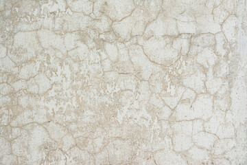 textured wall covered with cracked gray and white stucco