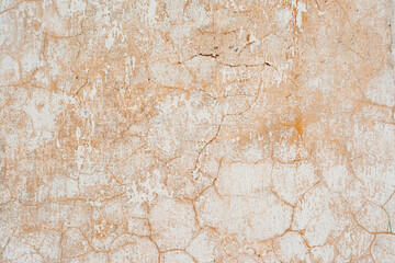 texture wall covered with cracked stucco of red and orange shades