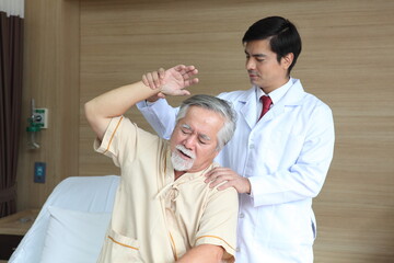 Physiotherapist or doctor checking with patient in hospital