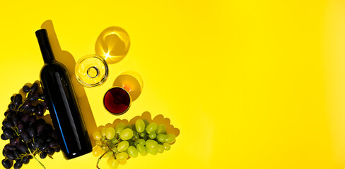 Two glasses of red and white wine, a bottle, grapes on a yellow background. The concept of Italian...