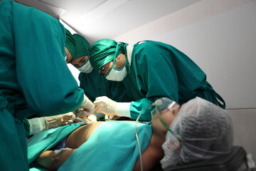 Team of professional surgeons performing operation in hospital operation theater