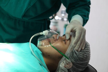 Team of professional surgeons performing operation in hospital , they are checking open eye while patient will die operation room at hospital