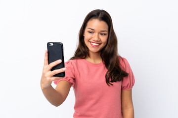 Fototapeta premium Young Colombian girl over isolated white background making a selfie
