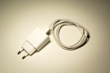 White phone charger with rolled-up cable