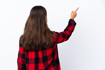 Young Colombian girl over isolated white background pointing back with the index finger