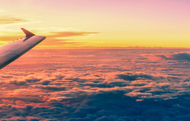 Flying aircraft wind on sunset sky view from window of airplane
