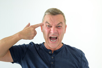 Angry man making a gun gesture pointing to head