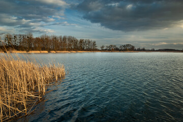 Gentle waves on the lake and cloudy sky