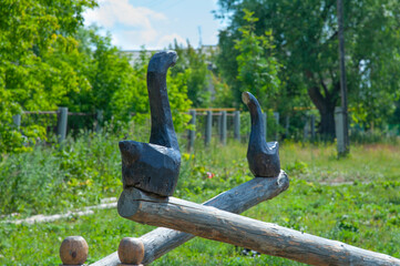 black swans carved in wood