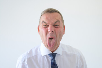 Rude aggressive man sticking out his tongue