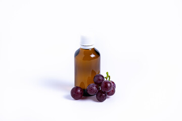 isolate bunch of grapes with a bottle of oil on a white background
