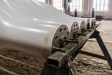 Two sets of new blades for wind generators in the factory floor close-up. The picture was taken in...
