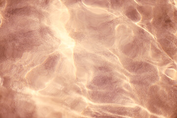 Obraz premium Close up of surface transparent coral sea water in a pastel tone on sunset, low angle view. Selective focus, bokeh