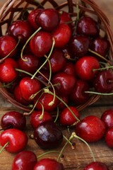 Ripe red cherries on a wooden table