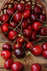 Ripe red cherries on a wooden table
