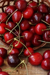 Ripe red cherries on a wooden table