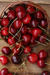 Ripe red cherries on a wooden table