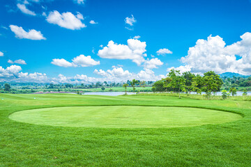 A beautiful view landscape in morning time green grass at golf course ,big trees, sand bunker and mist with sunlight rays background.