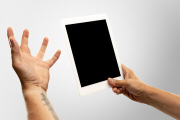 Angry, emotional. Close up male hands holding tablet with blank screen during online watching of popular sport matches, championships. Copyspace for ad. Devices, gadgets, technologies concept.