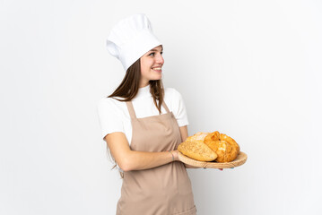 Young woman in chef uniform isolated on white background looking to the side