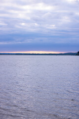 Sunset and blue clouds over the lake. Plenty of room for text.