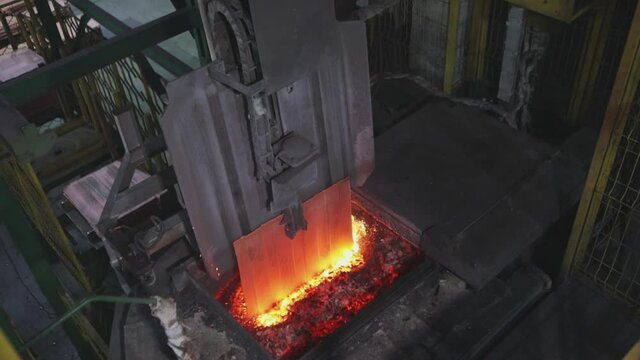 Automated copper feed line to the furnace. The melting of copper in the furnace, the process of melting copper in the furnace.