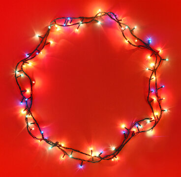 A circular border made with xmas lights. Space for text and headline.