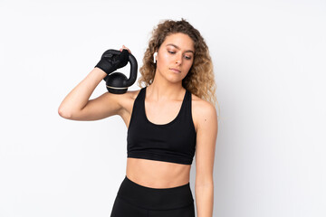 Young sport woman isolated on white background making weightlifting with kettlebell