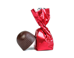 Milk chocolate candy in red glossy wrapping isolated on white background
