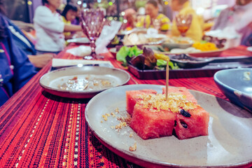 Fried dried fish with watermelon served as a dessert for party dinner in the restaurant