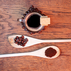 coffee beans and cup of coffee on wooden background