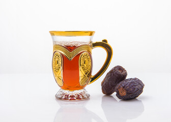 Arabic tea is popular throughout Arab world and it is served in a traditional cups with sweet dates...