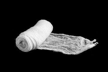Fototapeta na wymiar White bandage roll isolated on black background. Soft,made of cotton object