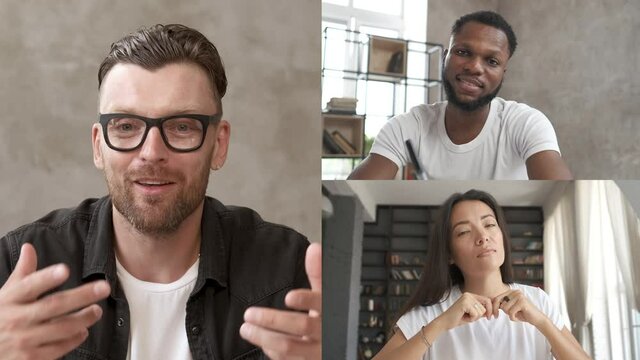 Remote communication of happy multiracial young people. Webcam view. College students listening to online lesson and writing notes in notebook. Business chat conference talking with tutor.