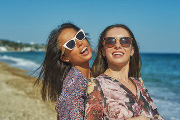 Young cheerful women on a walk along the sea