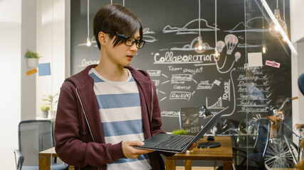 Talented Young Asian App Developer Leader Work With Laptop. Creative People in Stylish Loft Office...