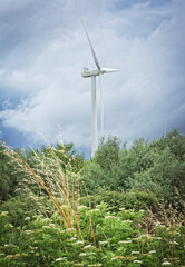 Wind mill on cloudy sky