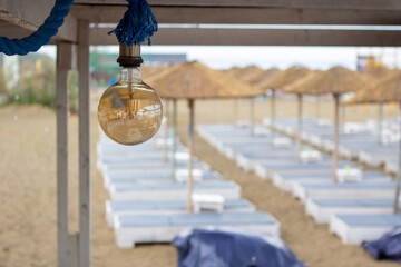 Focus on the light bulb at the beach bar. at least it is empty and there is no one.