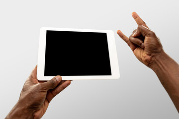 Rock horn, cool, drive. Close up male hands holding tablet with blank screen during online watching of popular sport matches, championships. Copyspace for ad. Devices, gadgets, technologies concept.