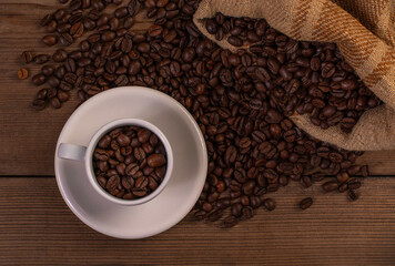 Coffee cup with coffee bag on wooden table