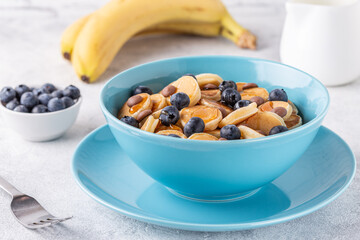 Trendy breakfast with mini pancakes, blueberries and chocolate chips.