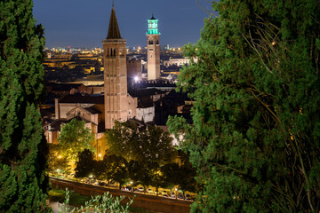 Night photo from the terrace of Castel San Pietro overlooking the Basilica of Santa Anastasia and Torre dei Lamberti, city of Verona, Italy.