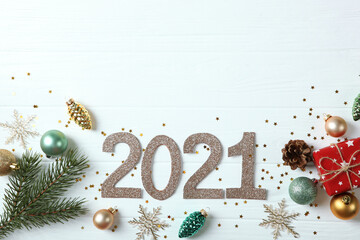 Composition with numbers 2021 and Christmas decor on a colored background top view
