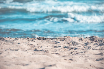 Summer and holiday concept with beach. Sand and wavy sea. Travel background.