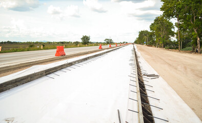 Geotextile under concrete road construction and concrete formwork with tie bar.