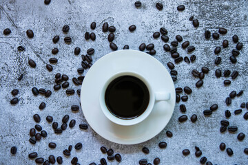 
Coffee cups and roasted coffee beans On the cement background
