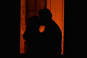 silhouette of a couple kissing