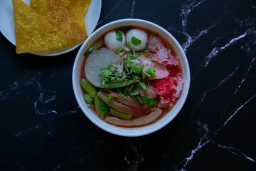 One type of noodles that has a mixture of red sauce is called Yentafo.