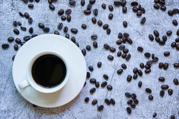
Coffee cups and roasted coffee beans On the cement background
